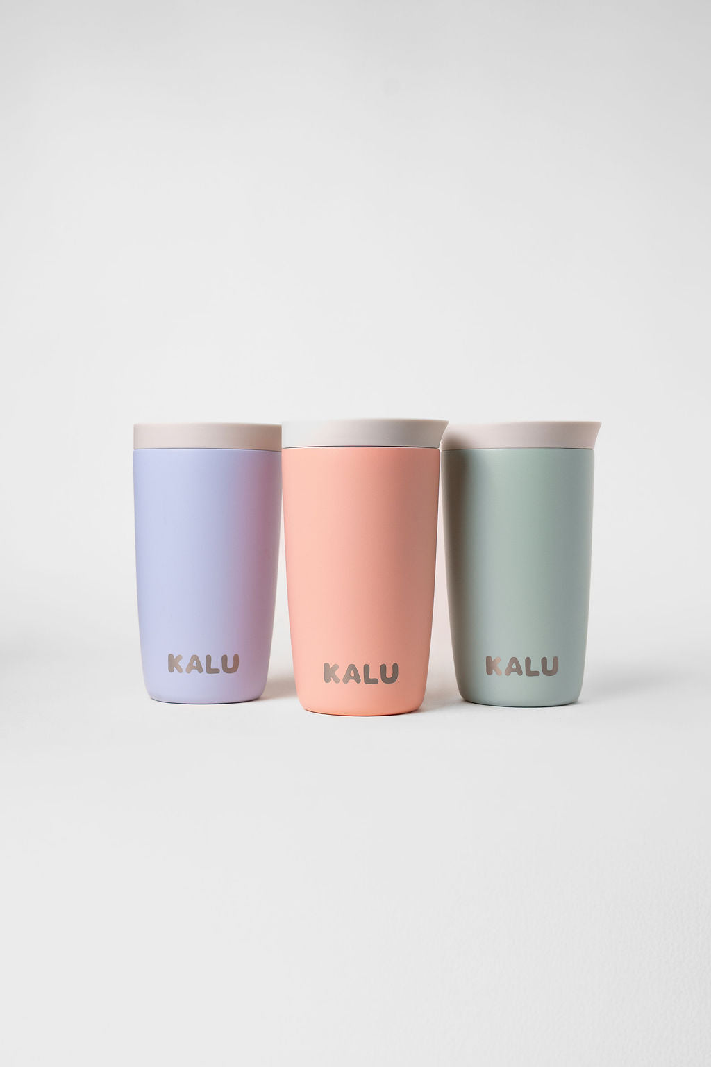 KALU reusable ceramic coffee cups in Coastal Blue, Sunrise Coral and Seafoam Green - leak-proof travel cups NZ